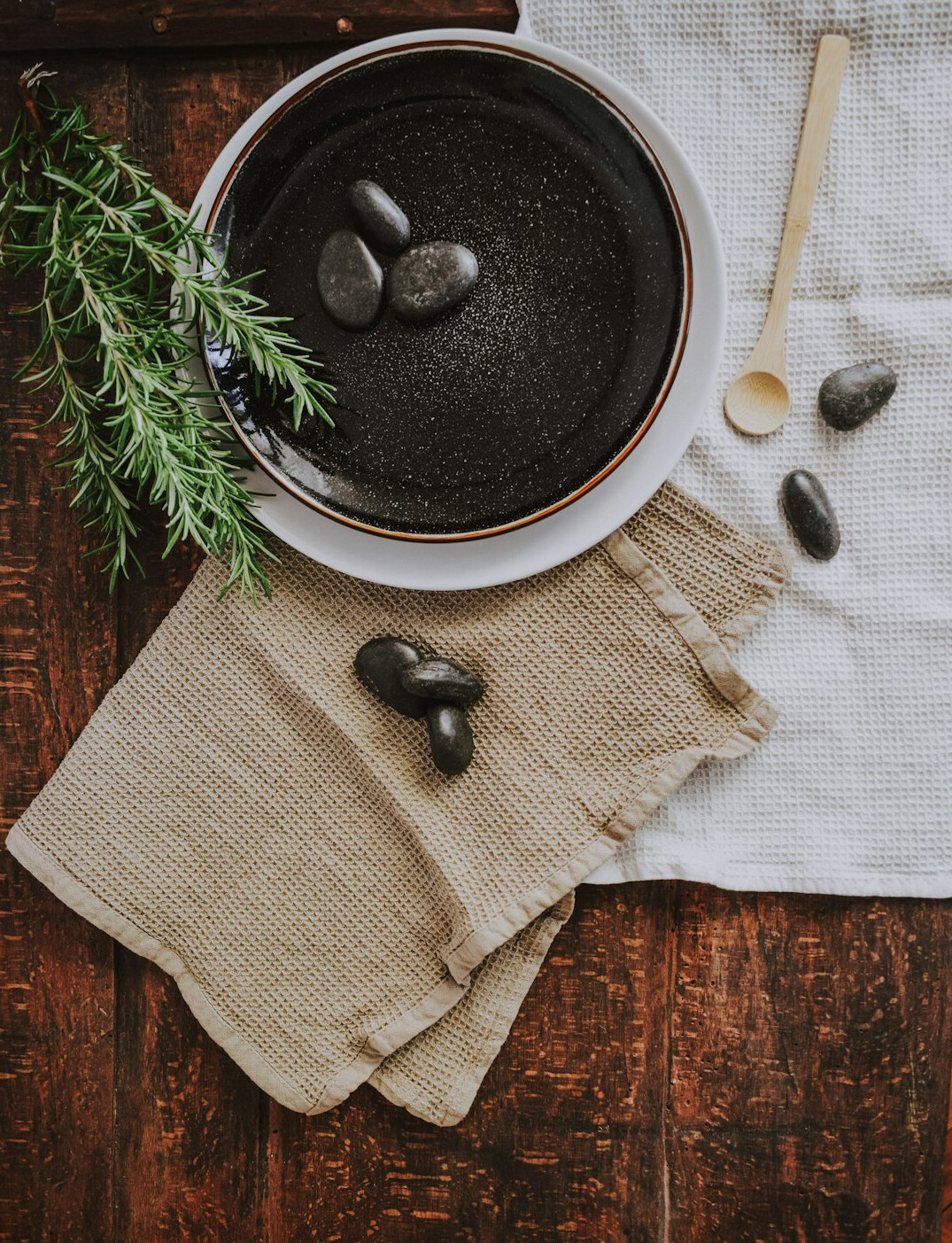 Spa relaxation setting with stones and towels